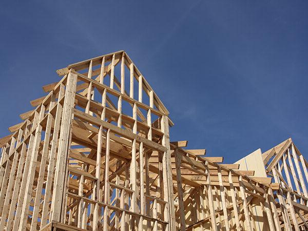 Building Frame Construction Against Blue Sky